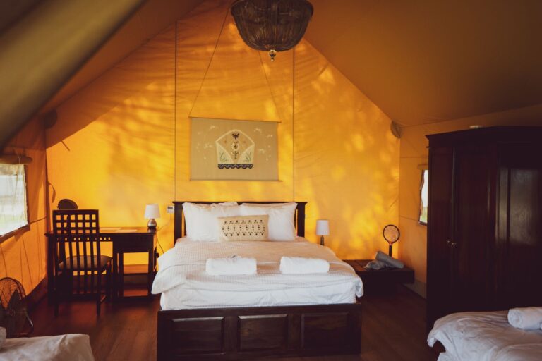 Family glamping tent interior at Mia Glamping in Saaremaa with warm lighting and wooden beds