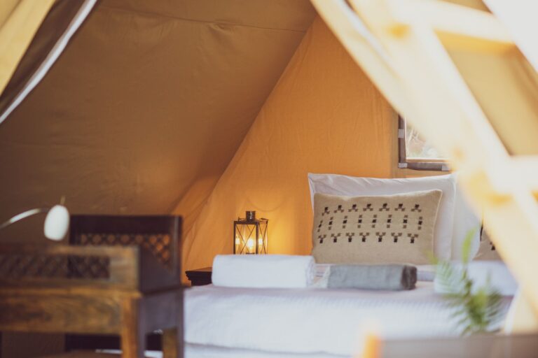 Queen bed inside glamping tent at Mia Glamping in Saaremaa with soft natural light