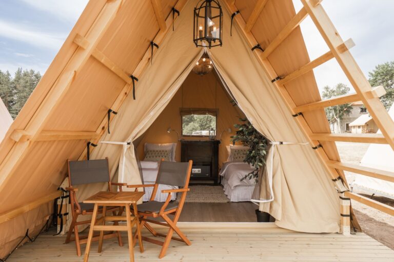 Twin bed glamping tent at Mia Glamping in Saaremaa with open front and outdoor seating