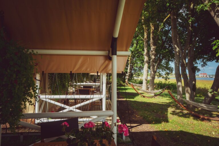 Covered terrace at Mia Glamping in Saaremaa with seating and garden view
