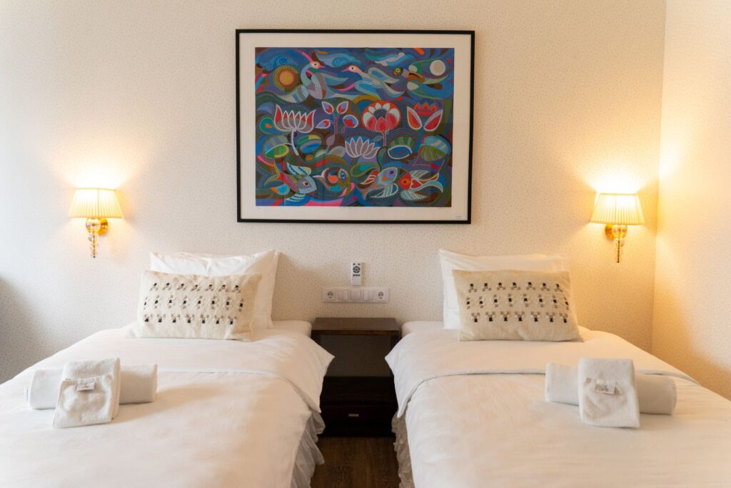 Twin beds setup in Mia Glamping hotel room in Saaremaa with soft lighting